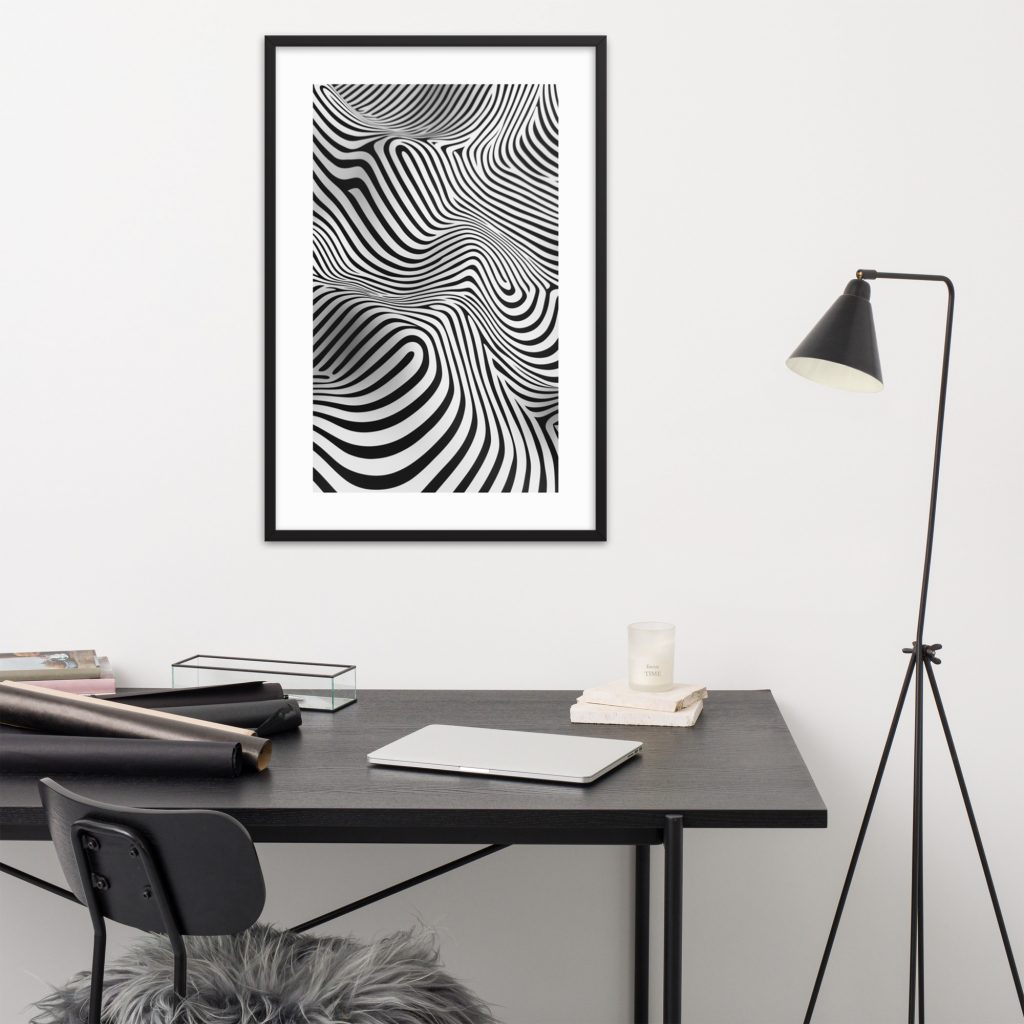 A modern workspace with a black desk and a black-and-white abstract art piece on the wall.
