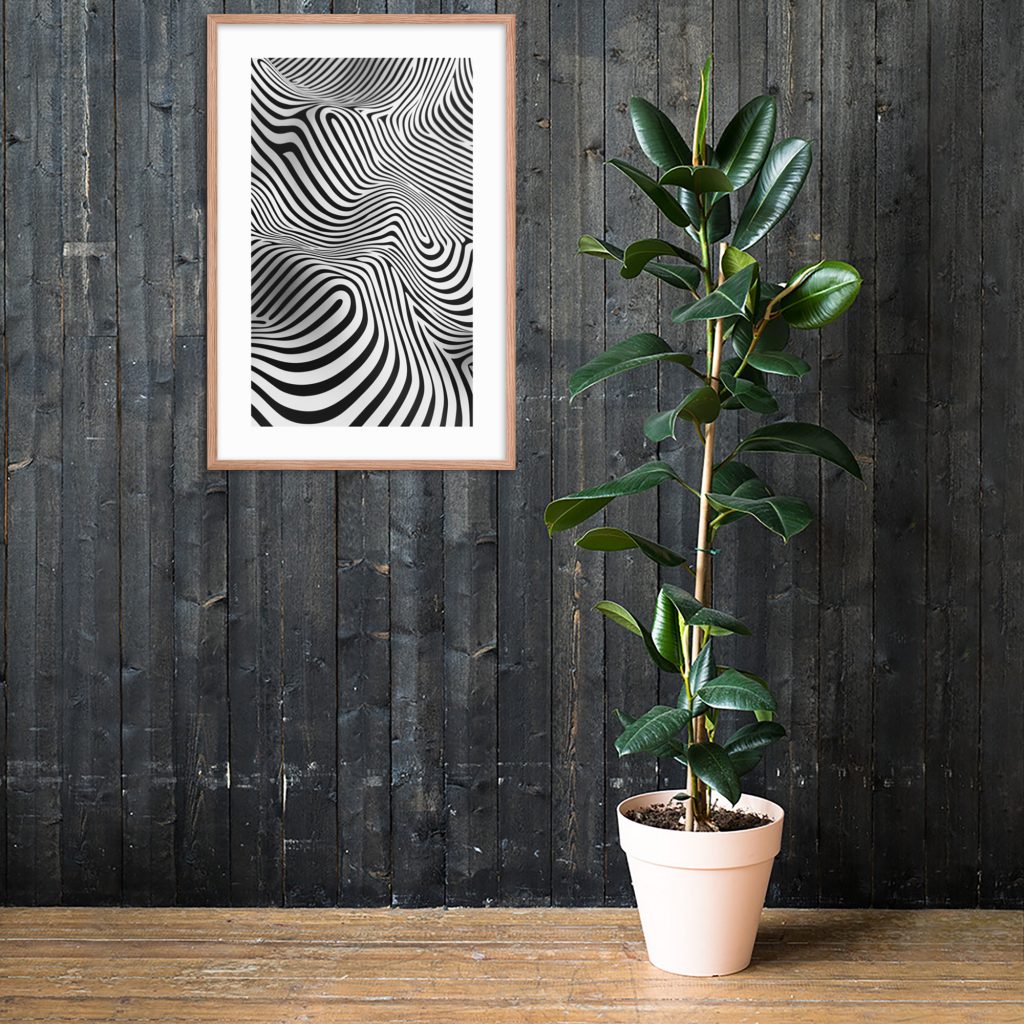 A potted plant placed in front of a black wooden wall with an abstract black and white art piece hanging above.