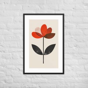 A framed abstract flower print with red petals and black leaves on a white brick wall.