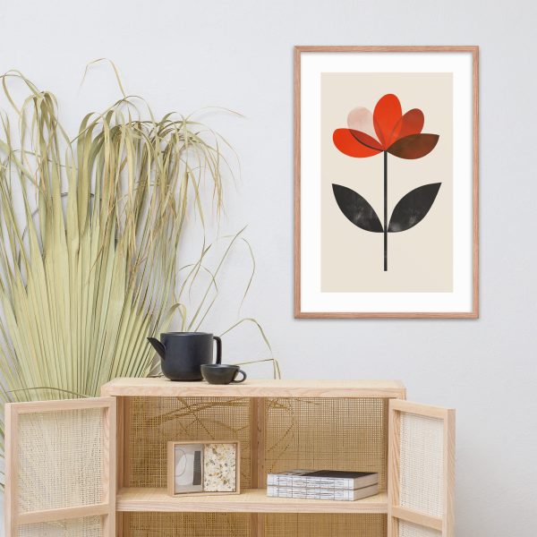 A minimalist room with a framed flower artwork, a plant, and a teapot set on a cabinet.