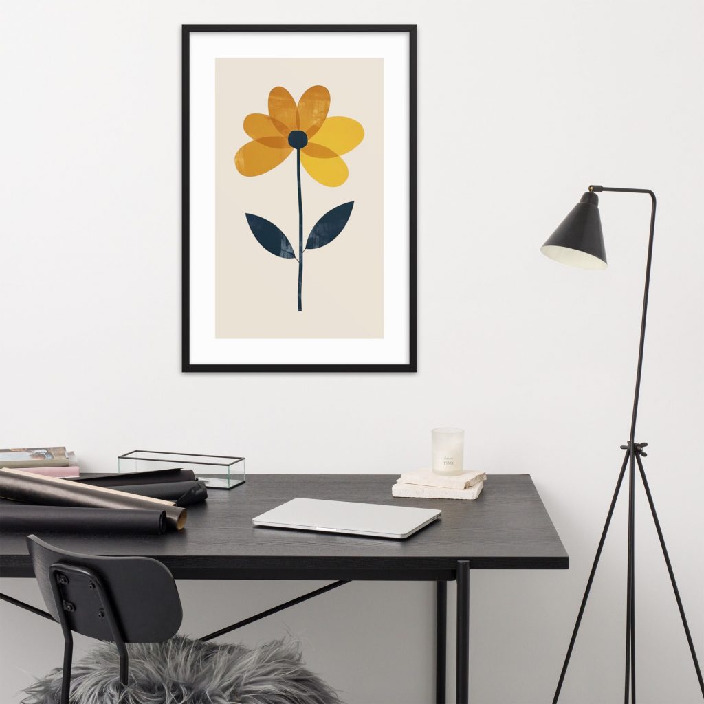 A modern workspace with a minimalist black desk, a framed floral art piece on the wall, and a floor lamp.