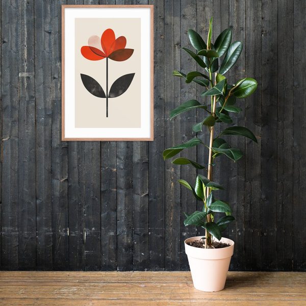 Minimalist flower art print above a potted indoor plant against a dark wooden wall.