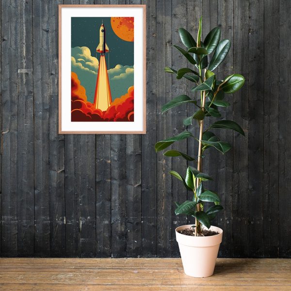 A framed rocket artwork hanging on a dark wooden wall above a potted plant.