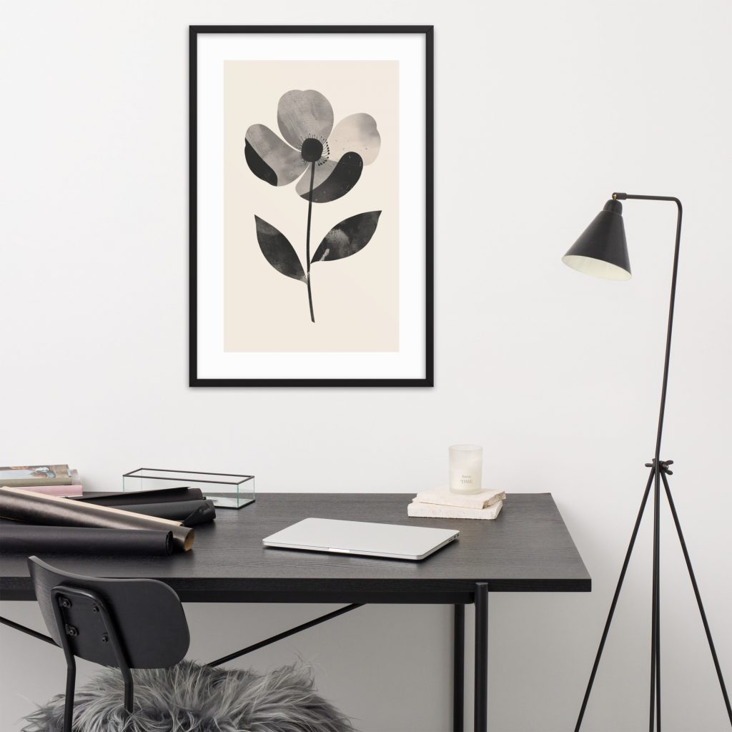 Minimalist workspace with flower painting and black lamp.