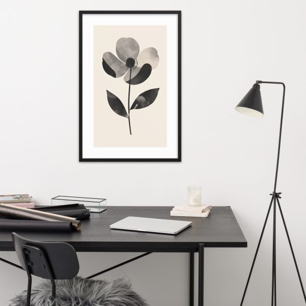 Minimalist workspace with flower painting and black lamp.