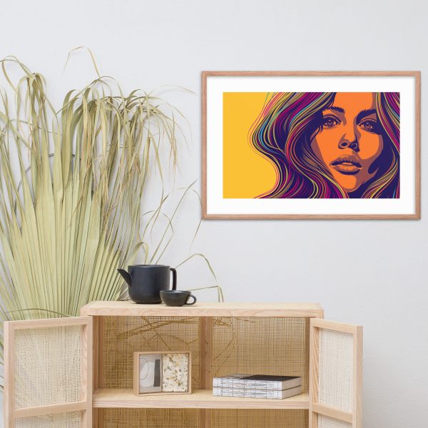 A framed modern art portrait of a woman with colorful hair above a wooden cabinet.