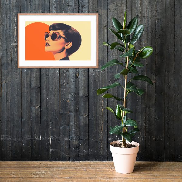 A framed modern artwork and potted plant against a dark wooden wall.