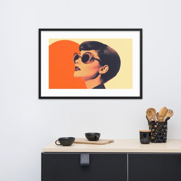 A framed retro-style portrait hangs above a minimalist console table with black and wooden utensils.