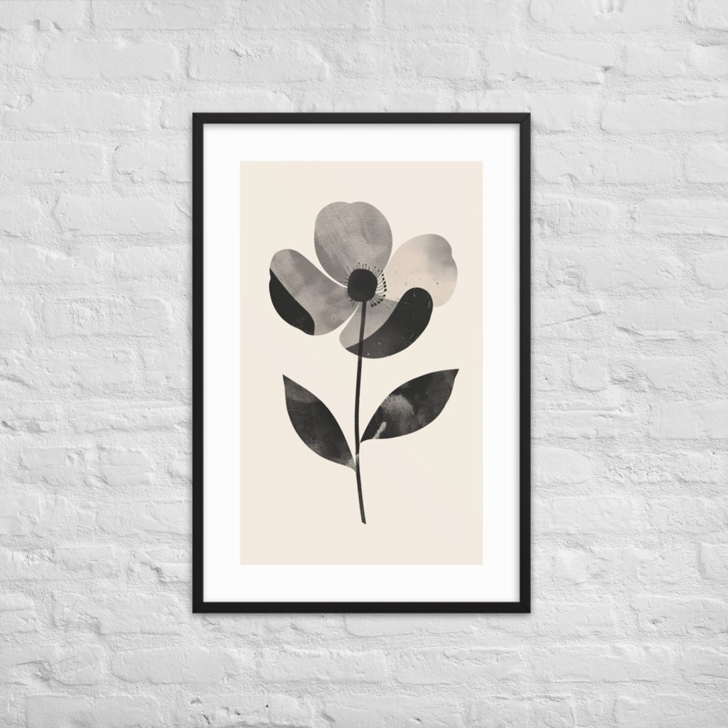 Framed black and white flower print on white brick wall.
