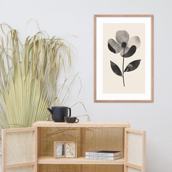 Minimalist room with framed flower art, wooden cabinet, black teapot, and dried plant.