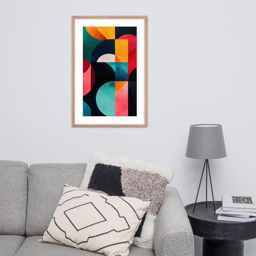 Abstract colorful geometric artwork on a light grey wall above a grey couch with pillows.