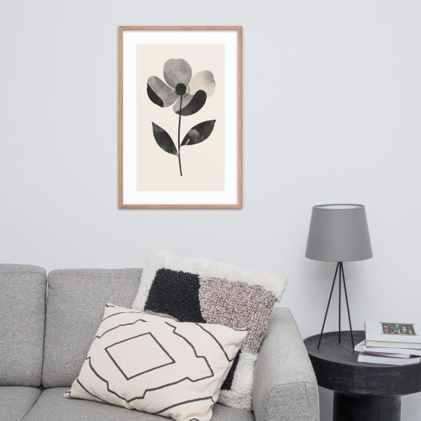 Modern framed floral artwork above a gray sofa with decorative pillows.