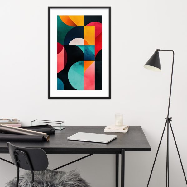 A modern office desk setup with colorful geometric artwork on the wall.